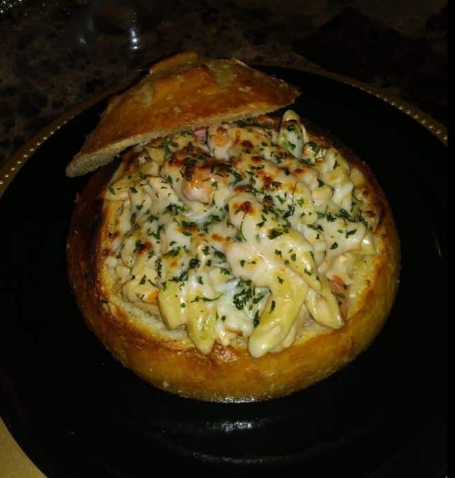 Blackened shrimp, chicken, broccoli Alfredo in butter garlic bread bowl