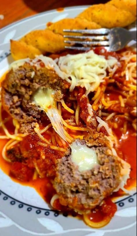 Homemade spaghetti with stuffed mozzarella meatballs ￼