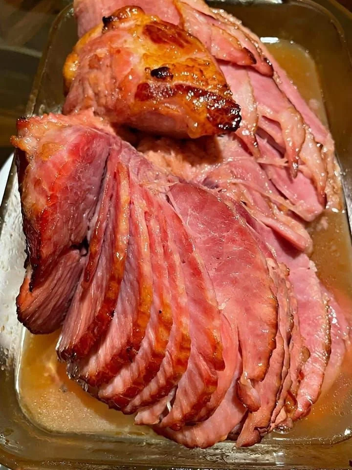 Baked ham with a brown sugar glaze served on a festive table