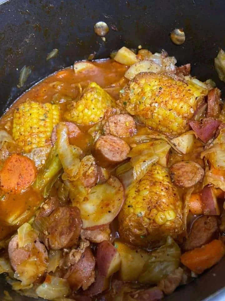 Delicious bowl of cabbage soup with smoked sausage and fresh vegetables