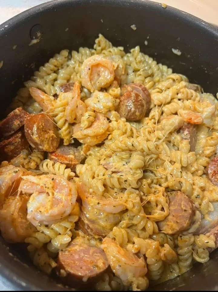 Bowl of Cajun sausage and shrimp pasta with vibrant vegetables and spices