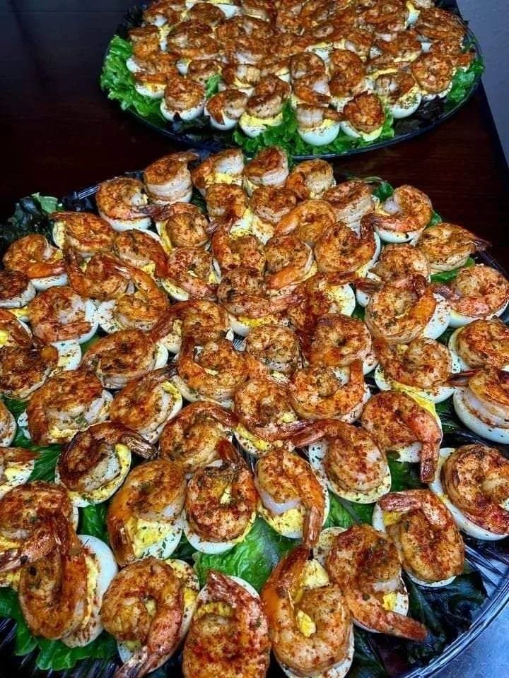 Cajun shrimp deviled eggs garnished with spices on a platter