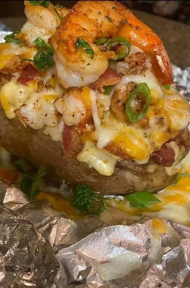 Cajun shrimp loaded baked potato topped with cheese and green onions