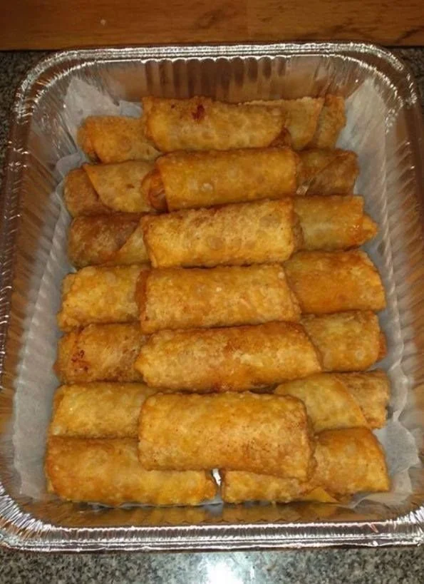 Philly Cheesesteak Egg Rolls served with dipping sauce on a plate.
