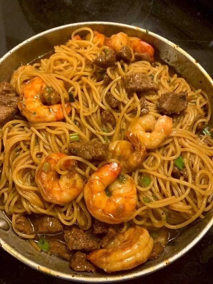 Plate of Shrimp Teriyaki Noodles with stir-fried steak and vegetables