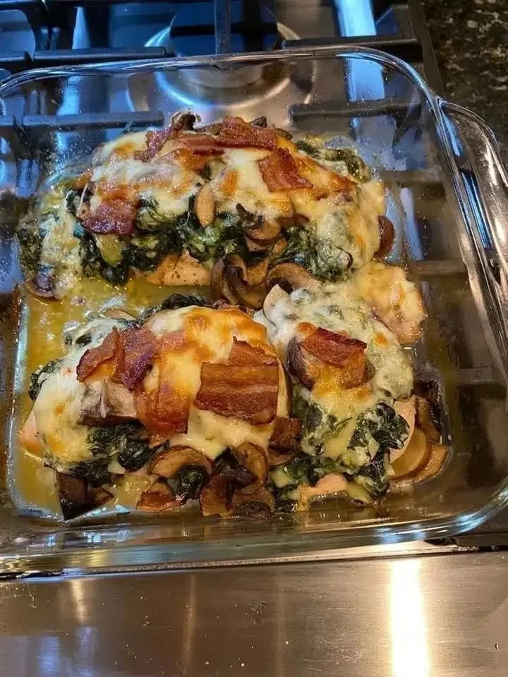 Delicious smothered chicken served with creamed spinach, bacon, and mushrooms